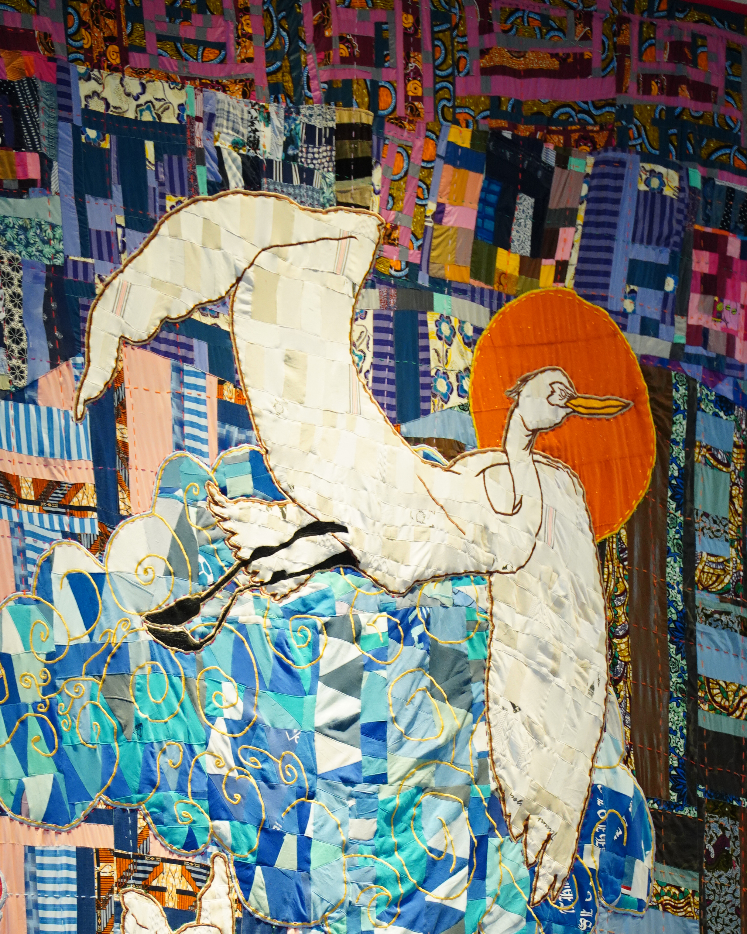 Image of a quilt with an egret flying