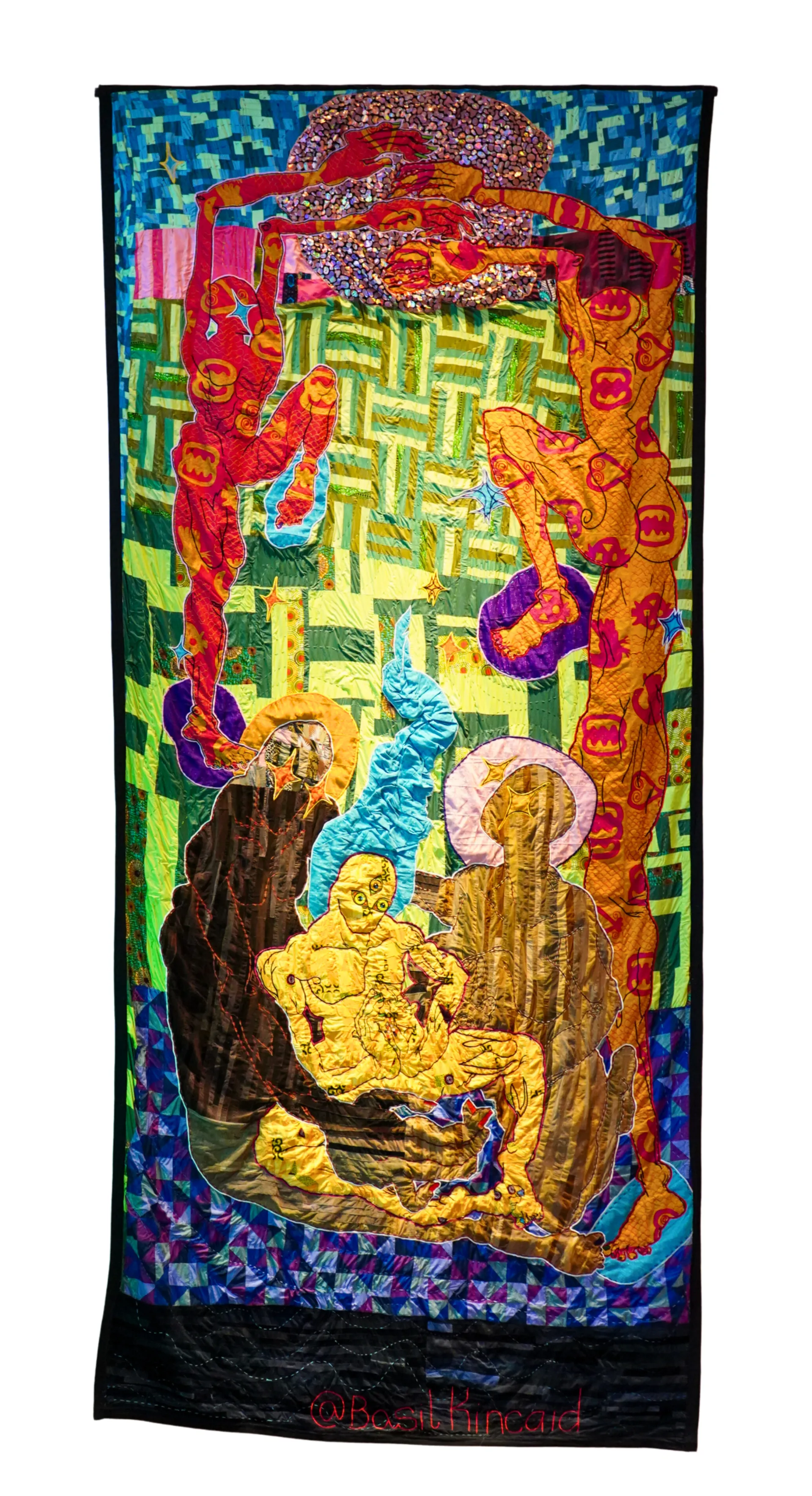 A photograph of a quilt with a person sitting down.