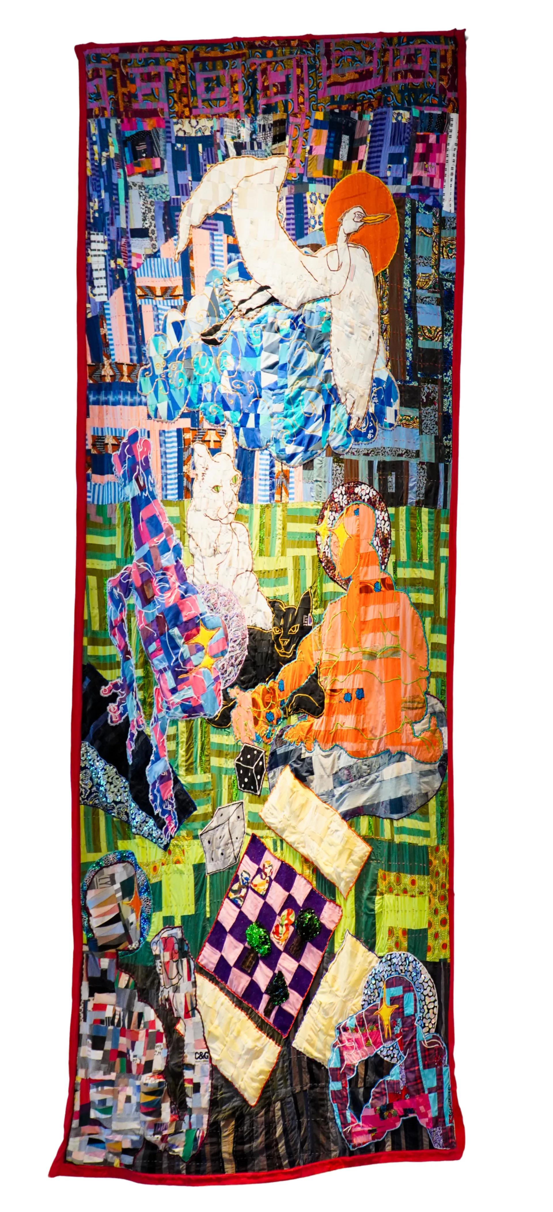 A photograph of a quilt with a person and feline animal.