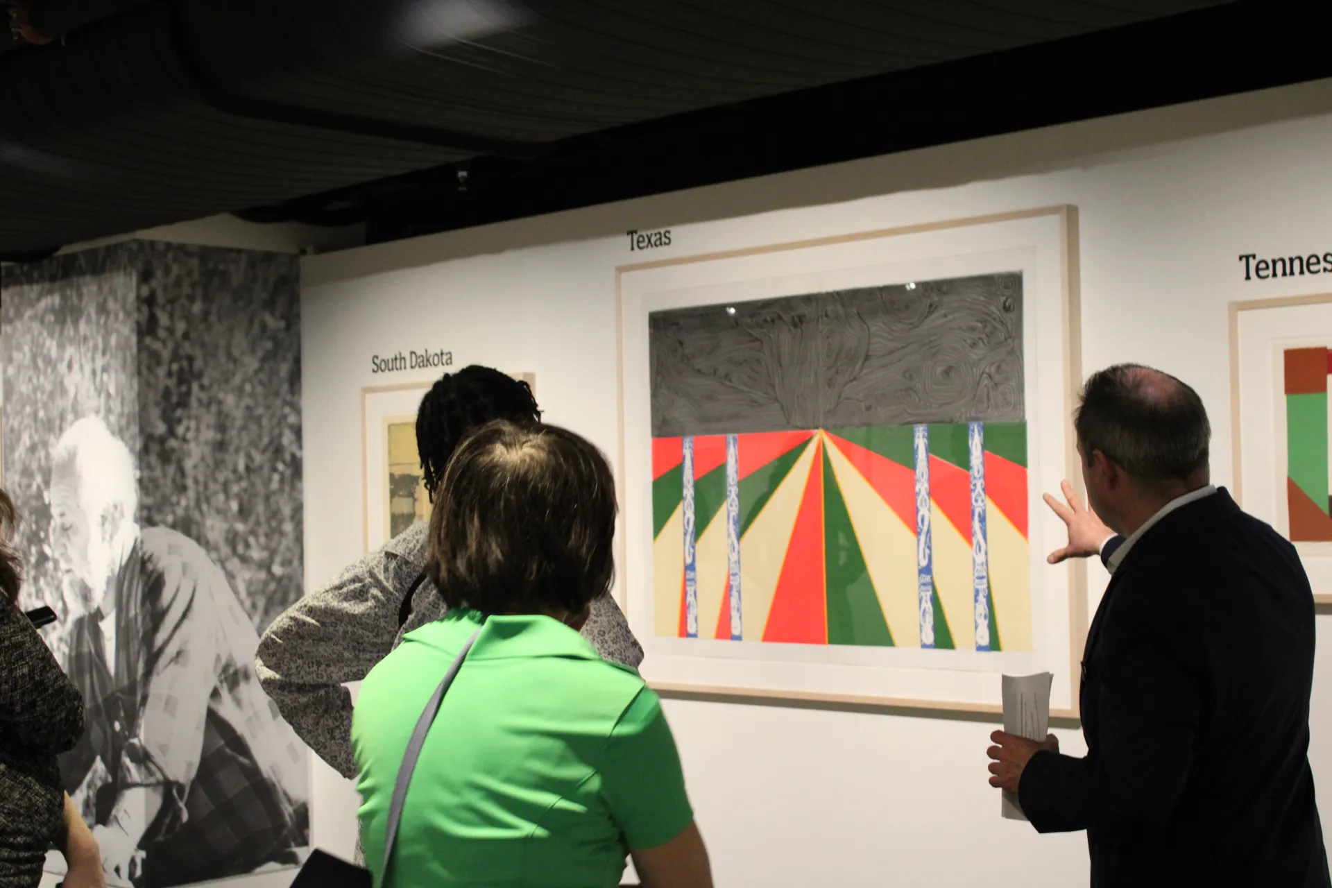 Visitors observe artwork. 