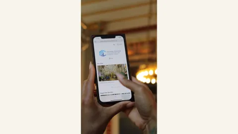 A photograph of someone using the Bloomberg Connects Guide